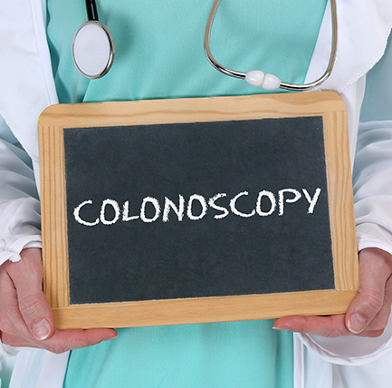 Colonoscopy written on chalkboard referring to colorectal cancer symptoms.