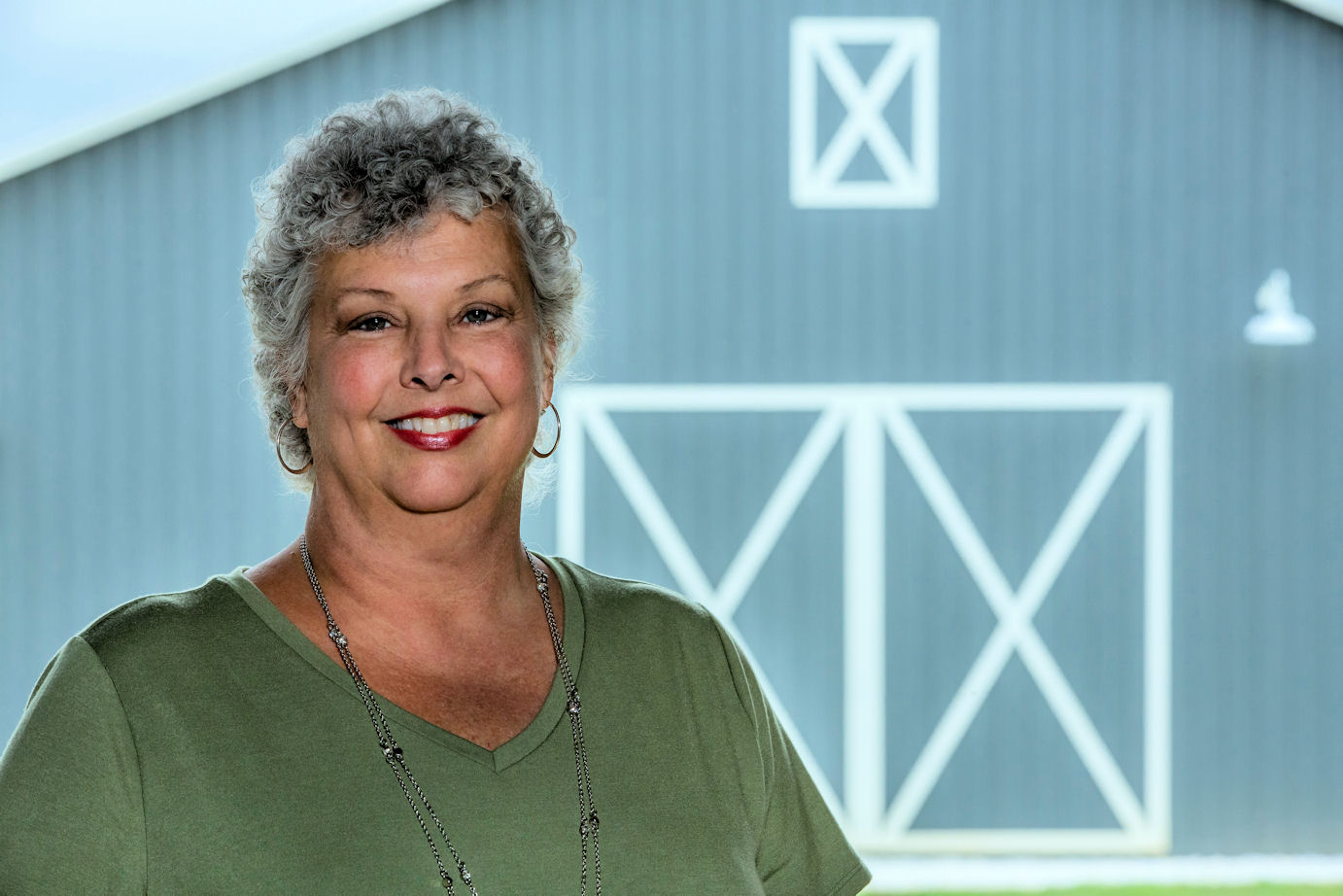 Carol Fulton in front of a barn