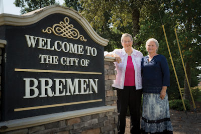 Bremen Mayor Sharon Sewell with city sign and friend
