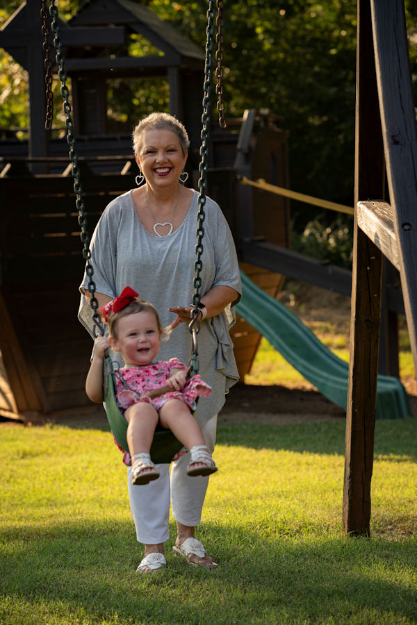 Sharon Campbell Easter pushing child in swing