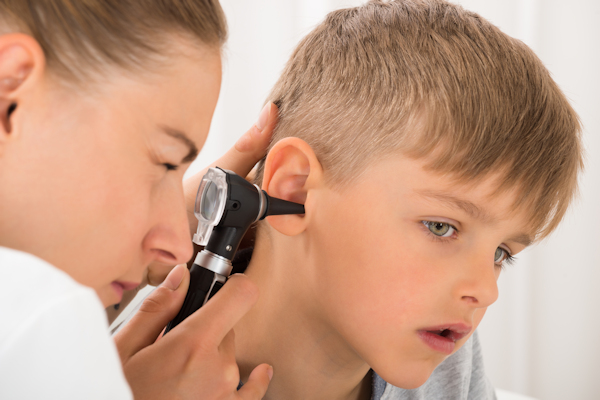 Doctor looking in boy's ear