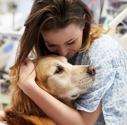 Female patient petting a dog.