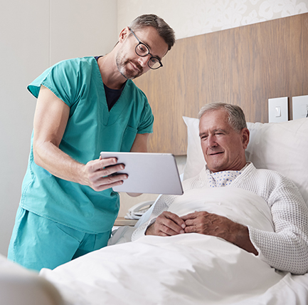 Doctor showing tablet to patient explaining colorectal cancer symptoms.