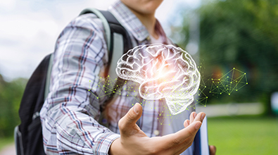 Man with backpack holding brain image