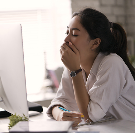 Sleepy woman at computer