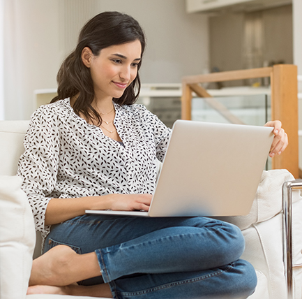 Woman at home using laptop