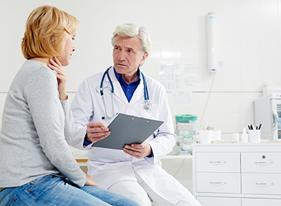Woman with sore throat talking to doctor