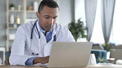 Young black doctor at computer