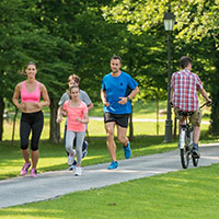 Photo of a healthy family enjoying exercise in a park.