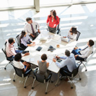 Photo of a leadership group around a table.