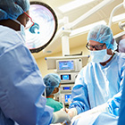 Surgeon performing a procedures in an operating suite.