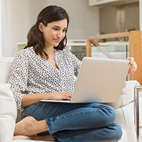 woman on couch with laptop