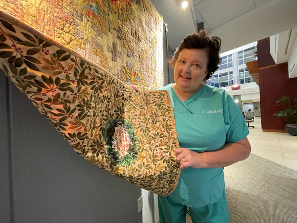 doctor with quilt she made