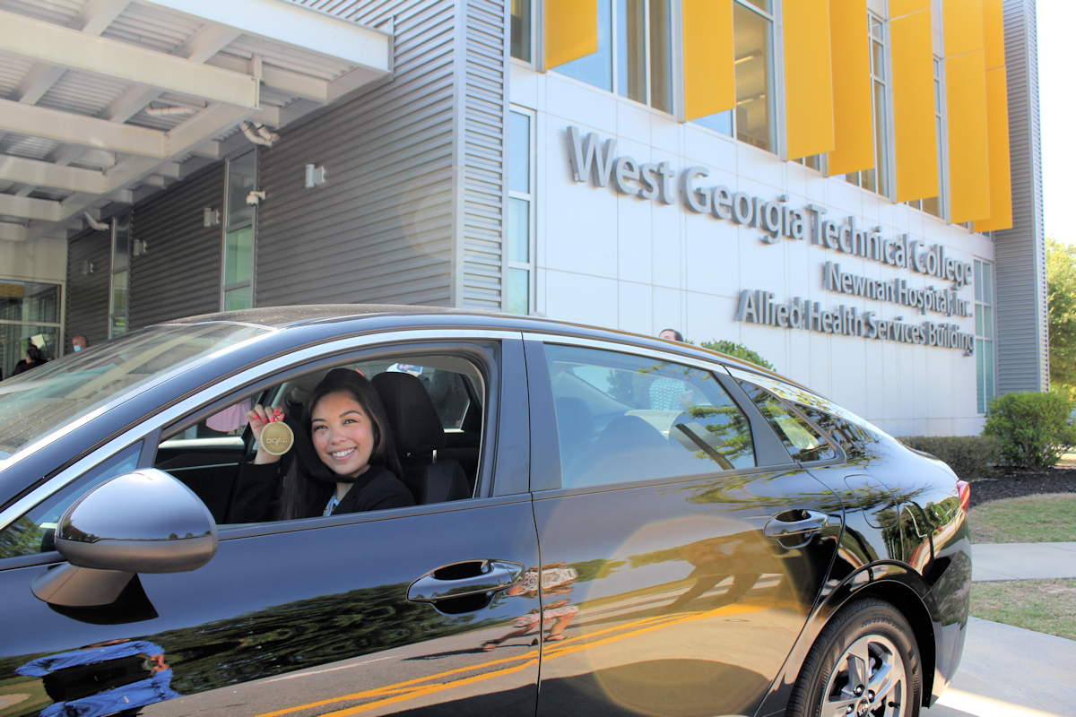 Elizabeth Rodriguez, RN, in her new KIA.