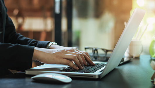 woman typing on a computer