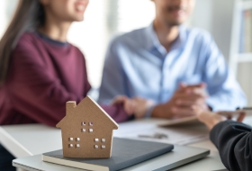two people talking with lawyer about their home