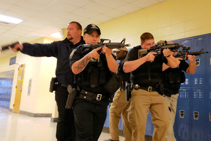 Police officers with guns in the hall