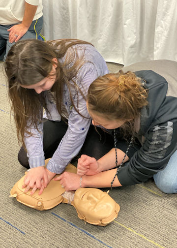 People doing CPR on the floor