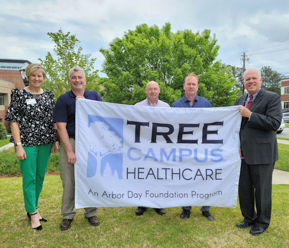 Tanner Tree Committee with banner