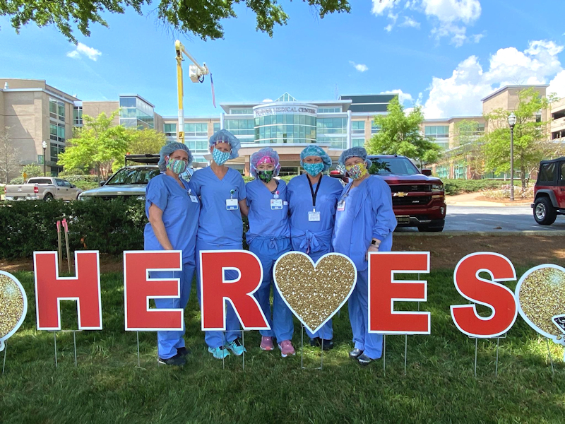 Tanner nurses with heroes sign