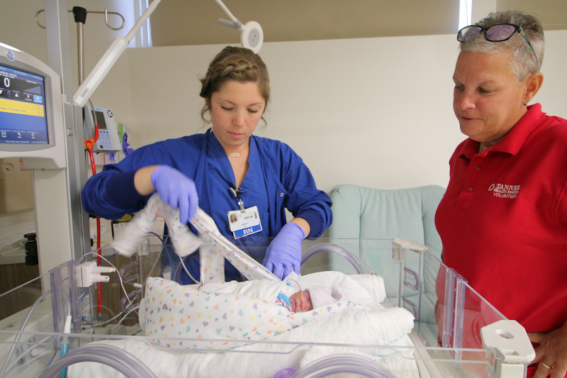 Tanner nurse and volunteer caring for NICU baby