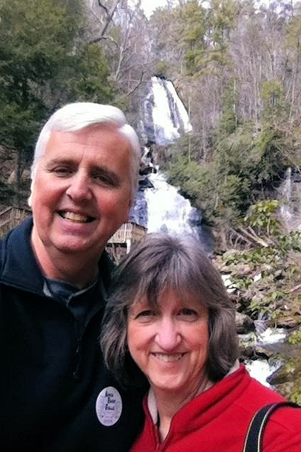 Laura Brown and husband hiking with waterfall
