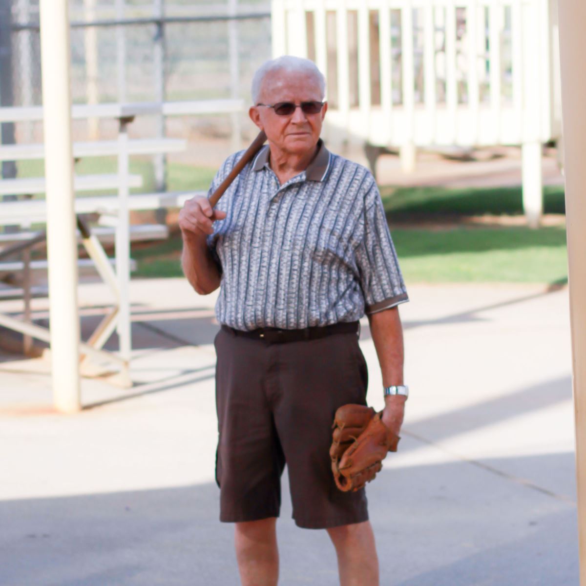 Lowell Elliot holding a baseball bat and glove
