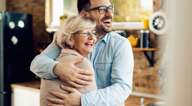 Happy mother hugging an older son.