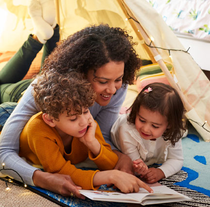 Mother reading with her two children.