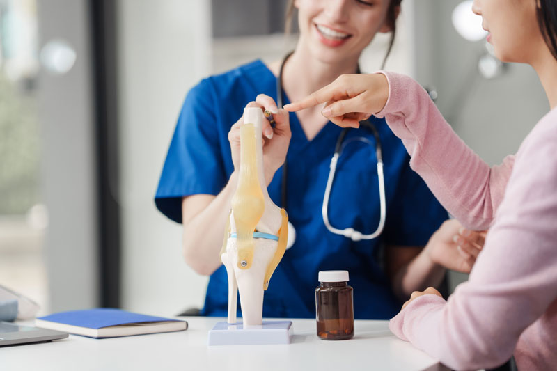 doctor-explains-knee-anatomy-to-patient-in-office