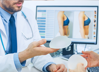 Doctors displaying a breast implant