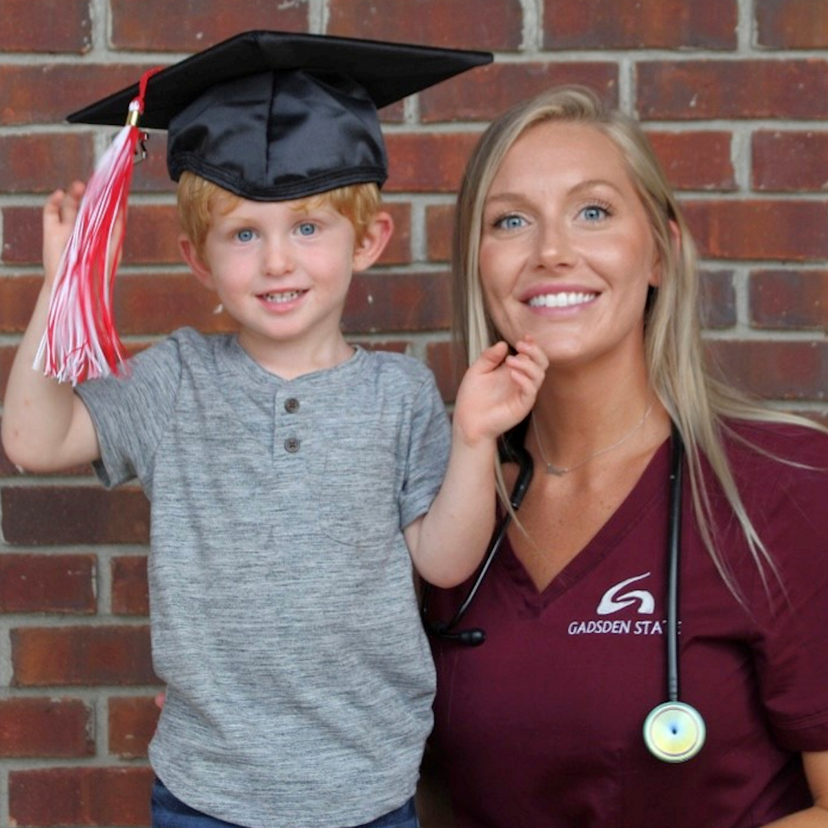 A photo of Courtney McAlpin and her son Knox wearing a graduation cap.